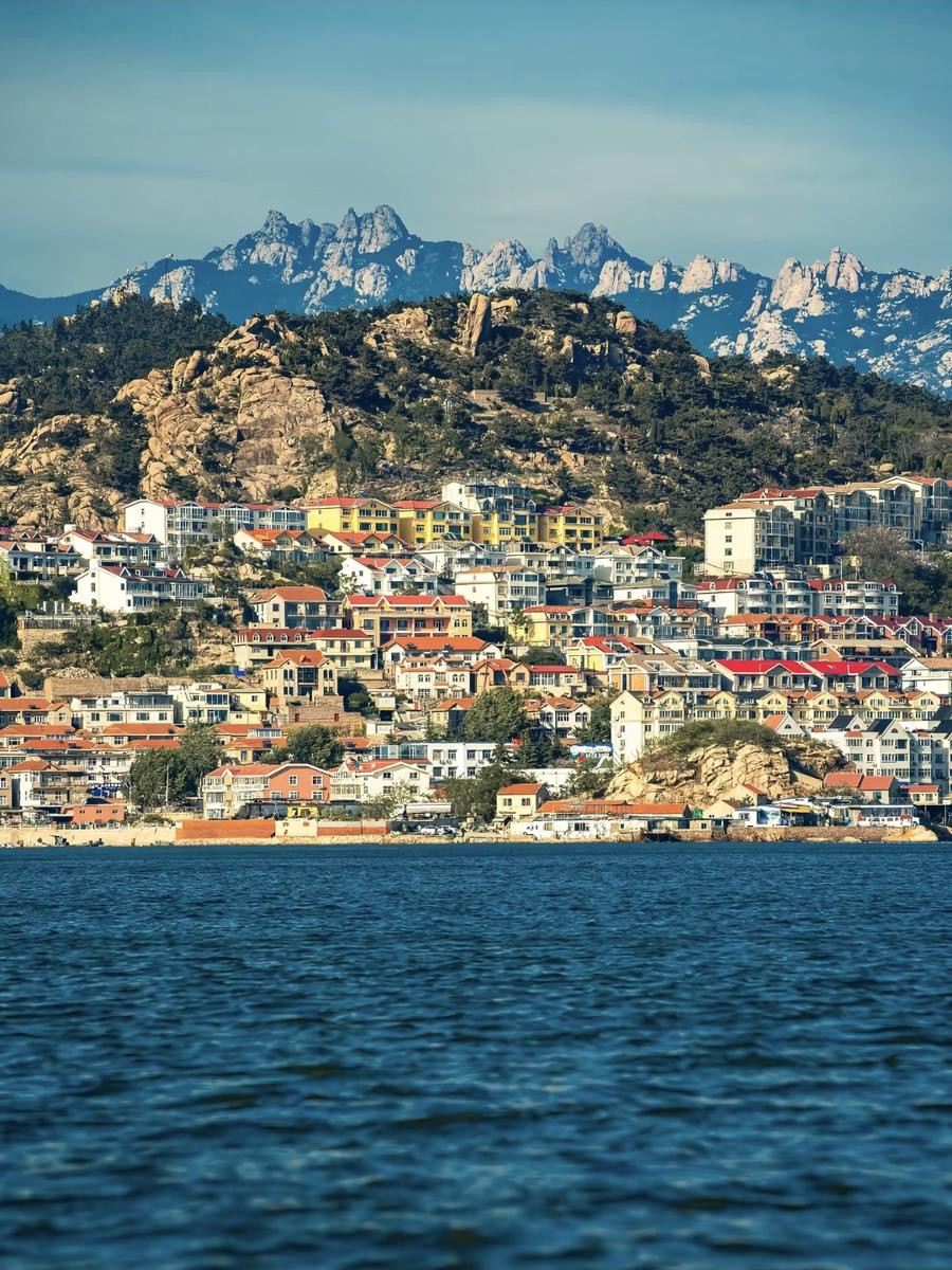 Laoshan mountains rising behind a coastal town
